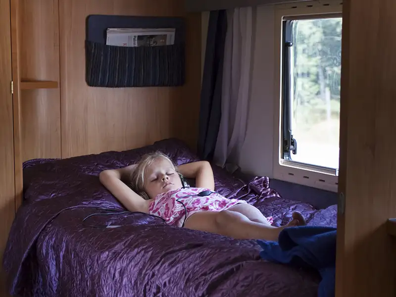 Are passengers allowed to sleep in an RV while it's moving?